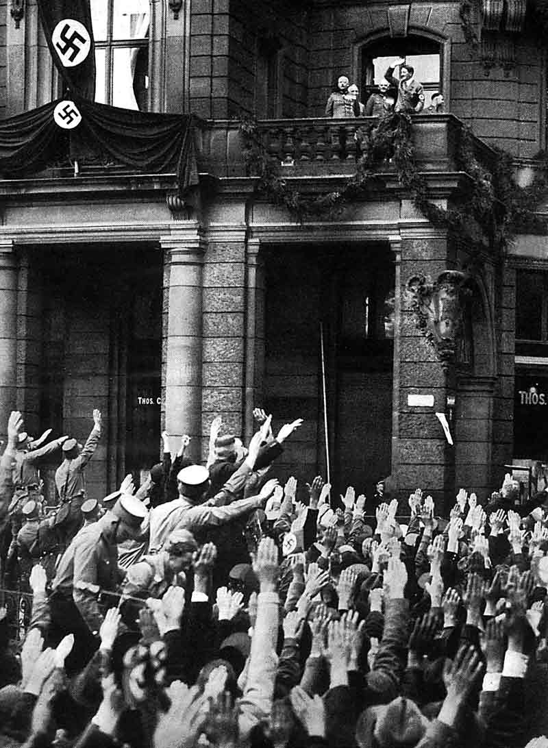 Adolf Hitler salutes the crowd from the balcony of the Hotel Dom in Köln (Cologne)